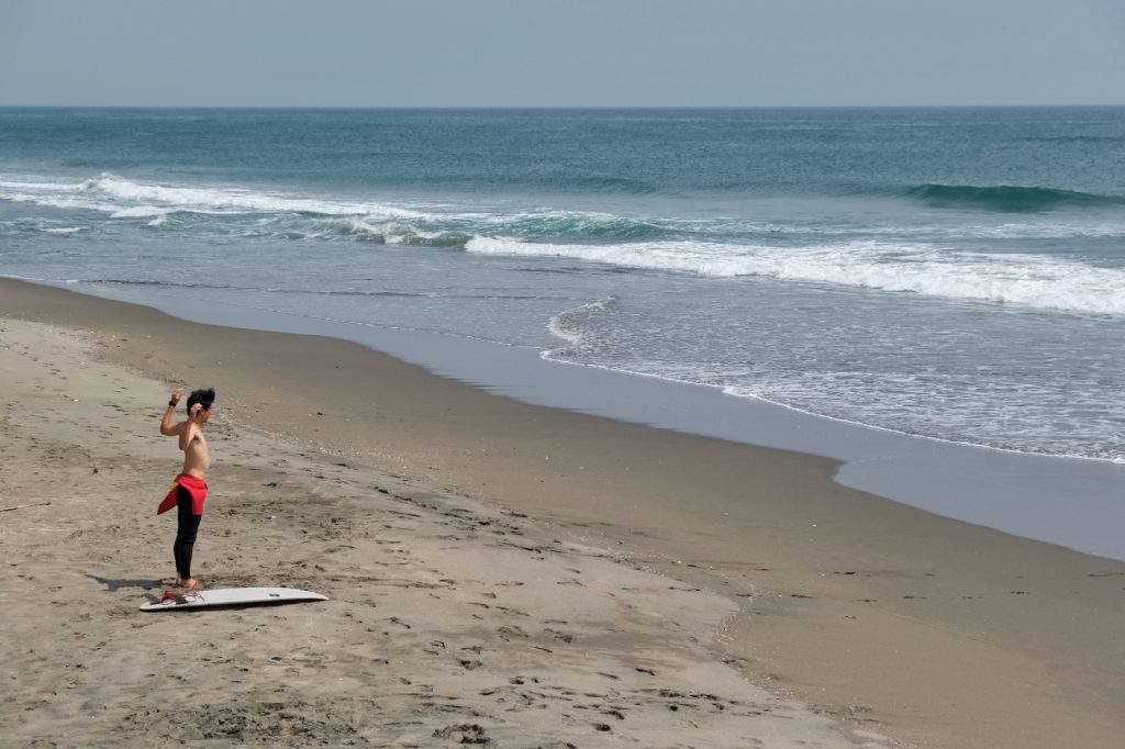 Un surfeur se prépare à braver l'océan Pacifique
